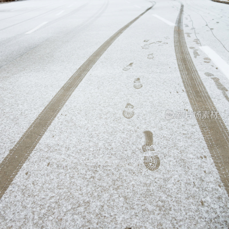 雪地上的轮胎痕迹和脚印