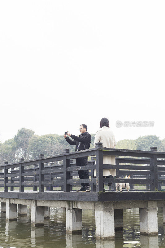 青年男女在木桥上拍照