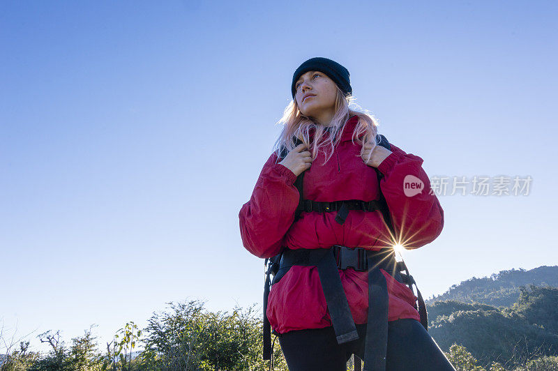 年轻女子在山间小径徒步旅行