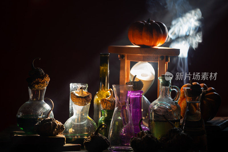 南瓜毒瓶和沙漏的照片在黑暗的万圣节