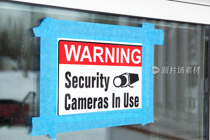 警告使用中安全摄像头的标志被轻按到窗口