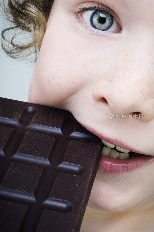小男孩在吃一大块巧克力。