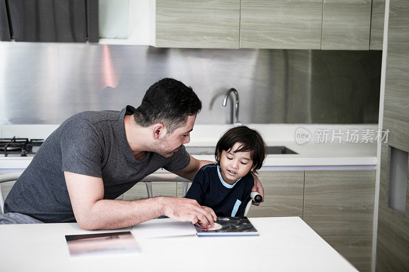 阿拉伯父亲读书与儿子在家