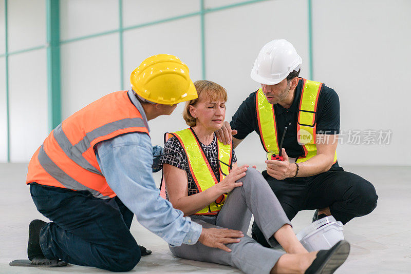 紧急救援工程师为发生事故的建筑工人提供急救。安全小组帮助发生事故的建筑工人。
