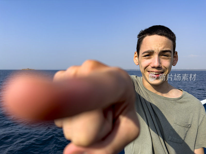 这个男孩正在北爱琴海的一艘男孩游船上旅行。体贴又快乐。晴朗的夏日。旅游的背景。旅游的概念。