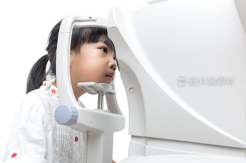 亚洲小中国女孩用自动屈光仪做眼睛检查
