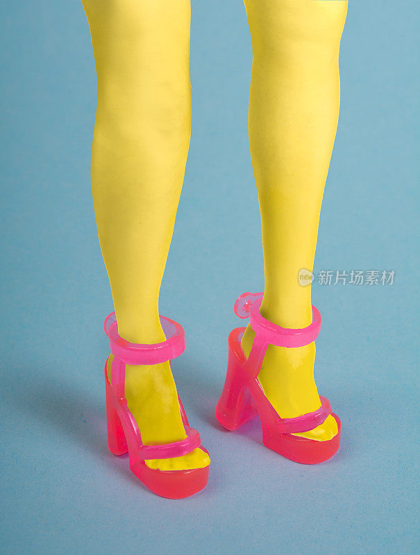 女人穿着黄色紧身裤和粉色透明玩具塑料凉鞋