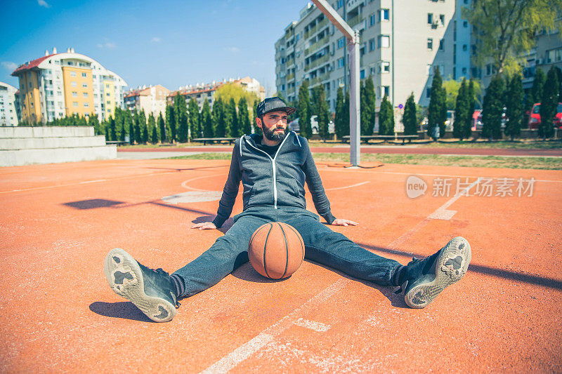 男篮球运动员坐在球场上