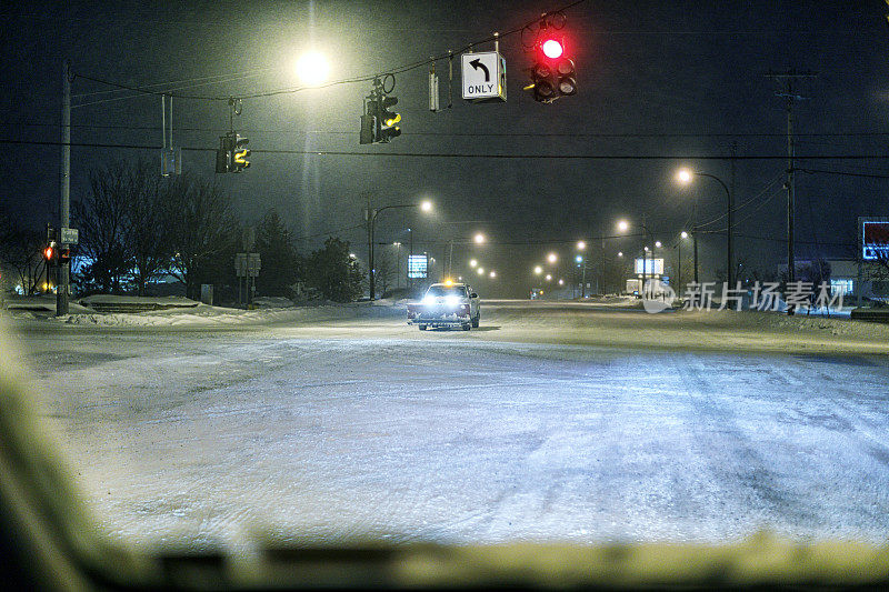 扫雪车在冰冻路口等待绿灯