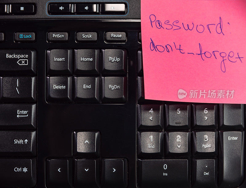 关闭的粉红色便利贴与密码，不要忘记和键盘的一部分