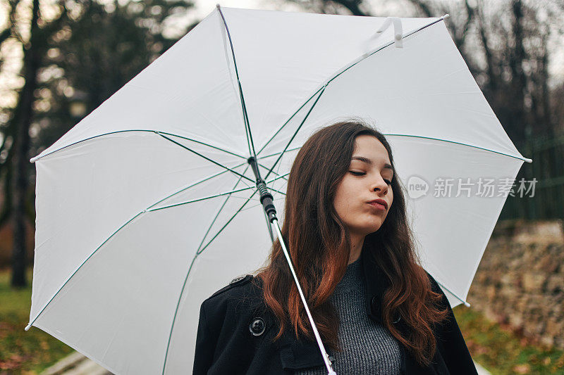 美丽的年轻女子享受着雨天