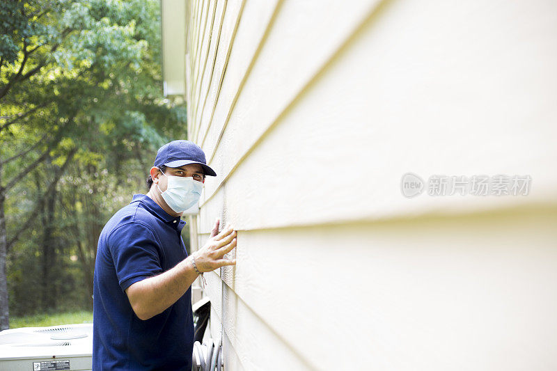 检查员或蓝领工人检查建筑墙壁。在户外。