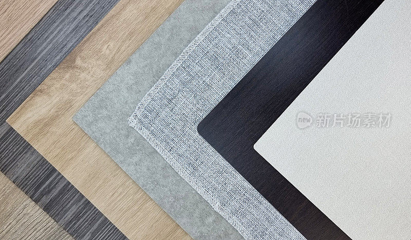 层叠多款室内建筑材料样品包括织物层压、灰帘、木层压和贴面。室内设计的采样材料纹理调色板。