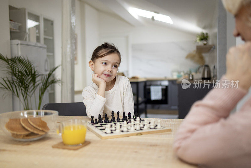 小女孩在家里下棋