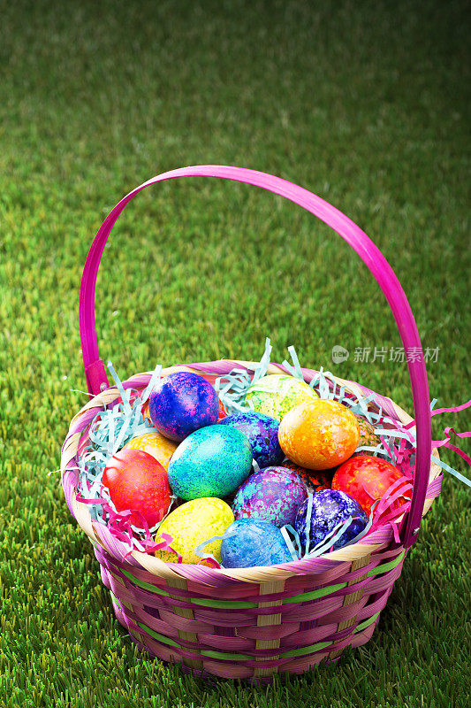 草地上装满复活节彩蛋的篮子