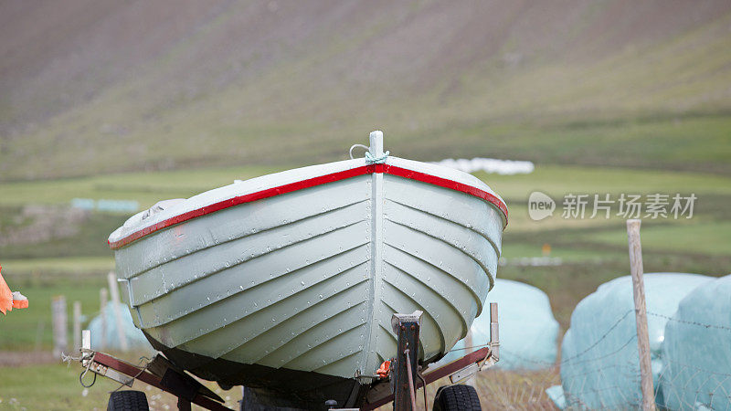 在西峡湾，一艘船越过一辆运输手推车。冰岛。