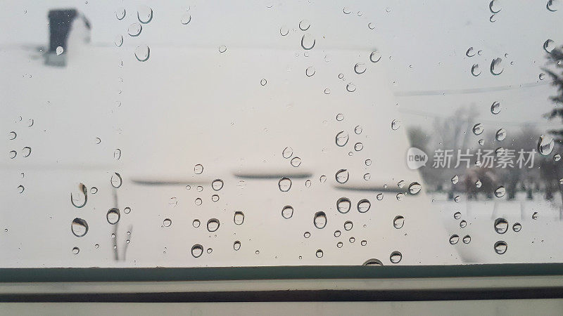 雨点落在窗户上。水珠落在家里的窗户上。坏天气的概念