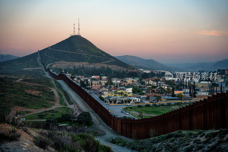 在特卡特边境，无人机在美丽的黄金时间自然光下查看美国和墨西哥之间的边界墙