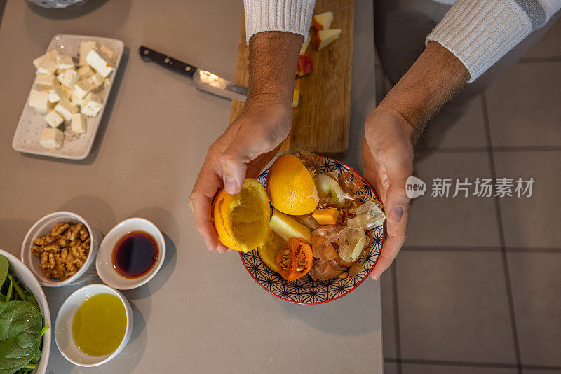 男子在自家厨房做饭，减少了家里的食物浪费