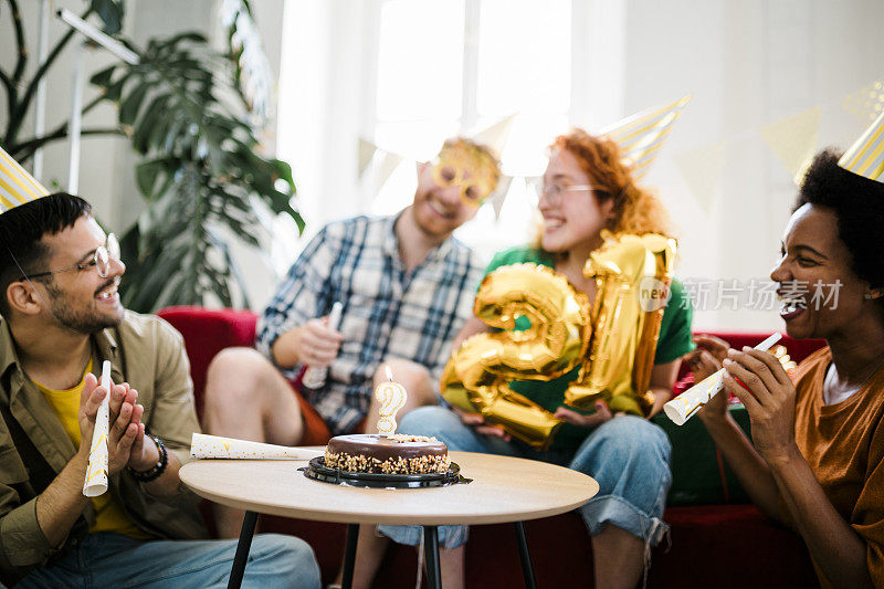 一群年轻人在享受生日聚会，朋友们在生日聚会上玩得很开心