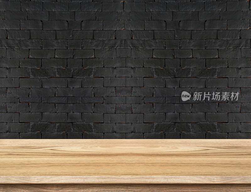 黑色砖墙上的空木桌