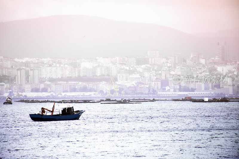 渔船的轮廓，在维戈市的背景。