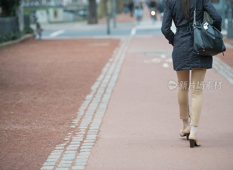 女人走在大街上，自行车道