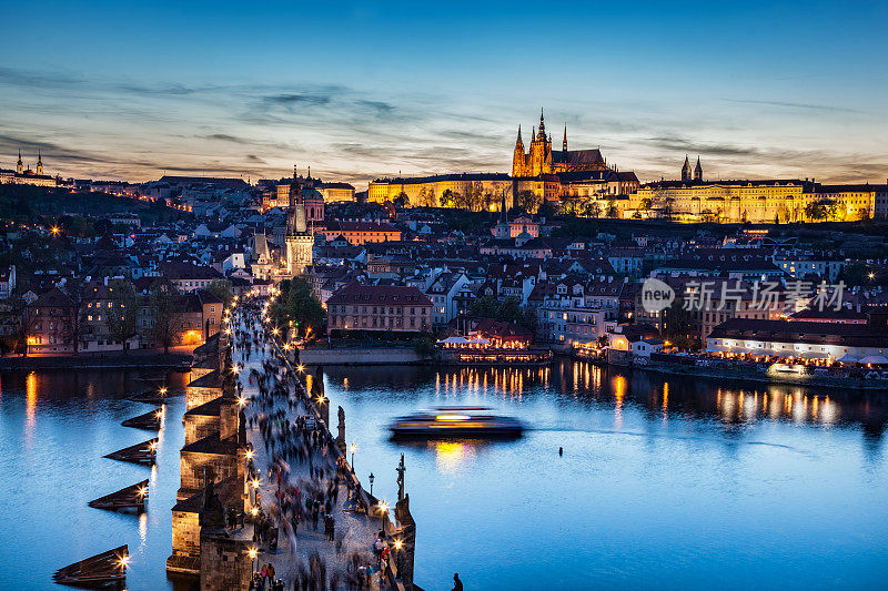 捷克共和国布拉格伏尔塔瓦河上的查理大桥，夕阳西下的夜晚。布拉格城堡