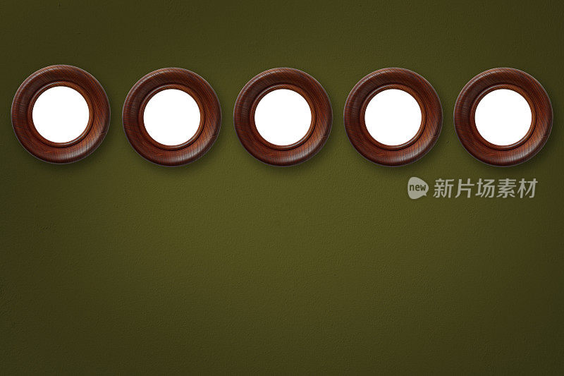 一排空白的木制圆形画框仿造在深绿色的墙上。
