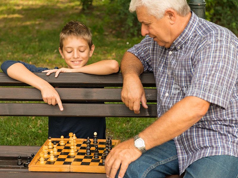 爷爷和孙子在公园里下棋