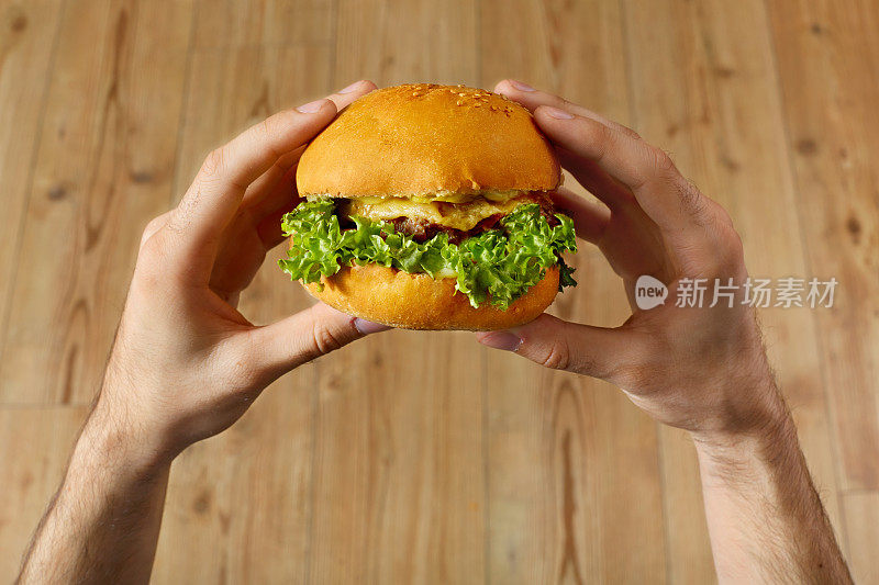 吃快餐。手拿着汉堡。的观点。营养