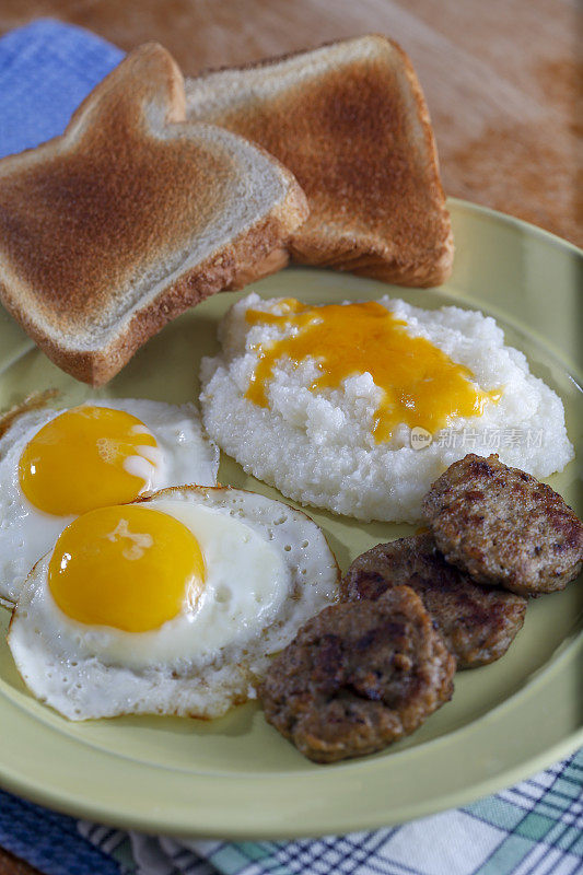 丰盛的早餐有鸡蛋、香肠、粗燕麦和烤面包