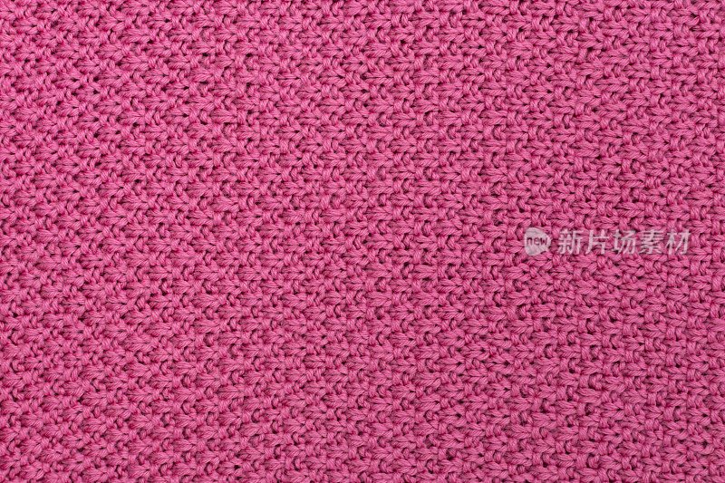粉红色针织面料珍珠羊毛背景。织物的结构具有自然的纹理。织物的背景。针织羊毛背景。