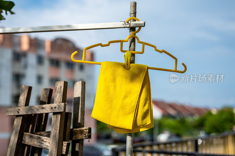 晒干黄色毛巾时，把它挂在晾衣架上