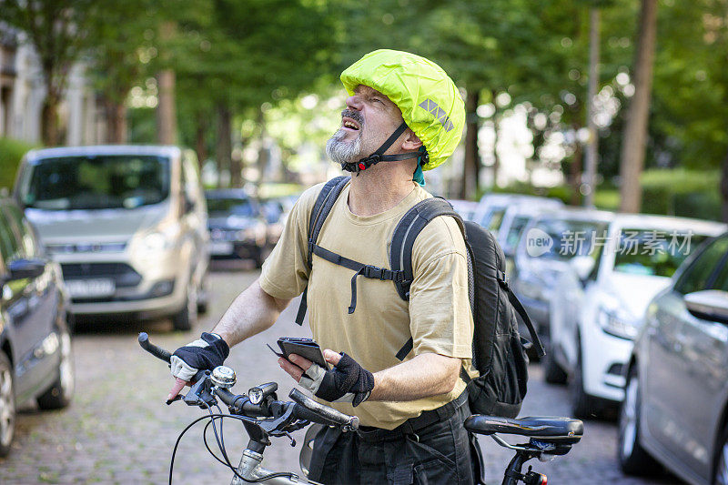 一个骑自行车的男人在用手机查地址