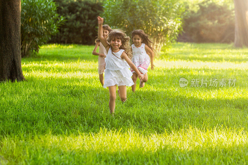 在阳光明媚的夏日，女孩们在公园里跑步