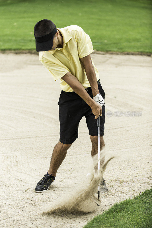 高尔夫球手在沙坑里打球