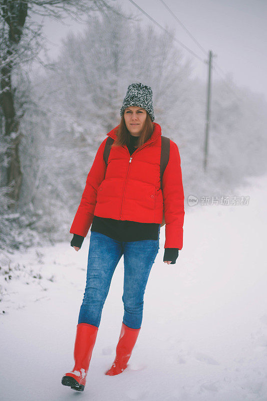 冬季运动活动。女徒步旅行者背包和雪鞋在雪地上的雪鞋