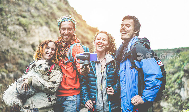快乐的徒步者人们制作视频视频为社会网络故事与gimbal手机-年轻的徒步者朋友在山远足日有乐趣-技术趋势和运动概念-关注左家伙