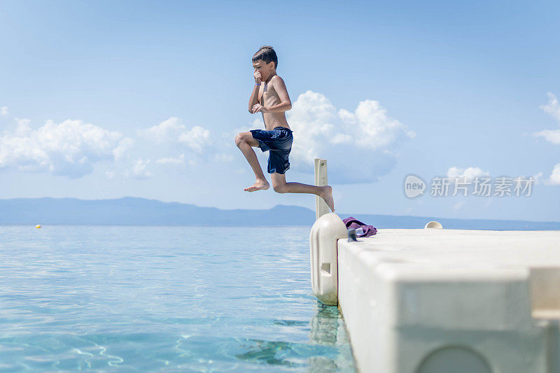 暑假男孩在海水里跳