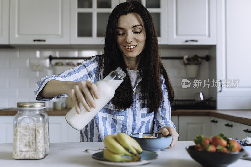 女人在厨房享用早餐。准备健康早餐。