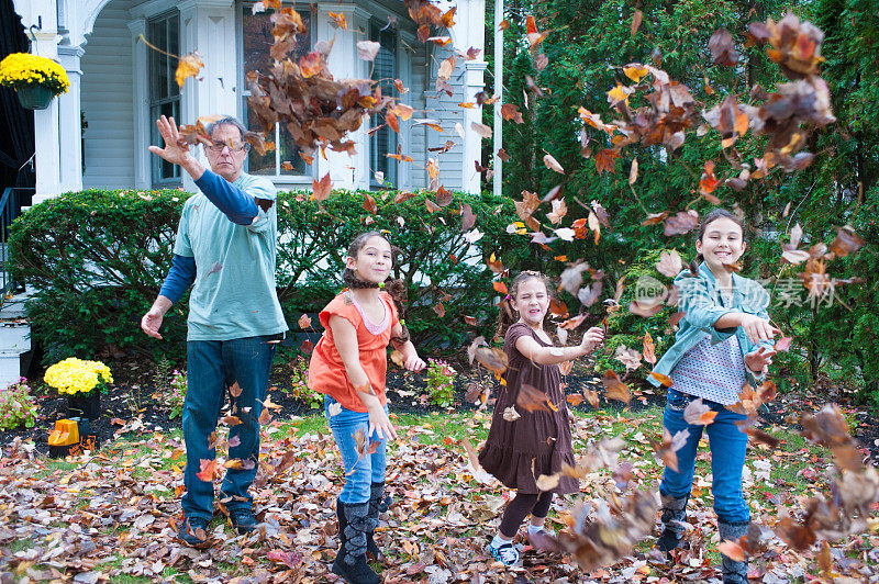 爷爷和孙子们玩秋天的树叶