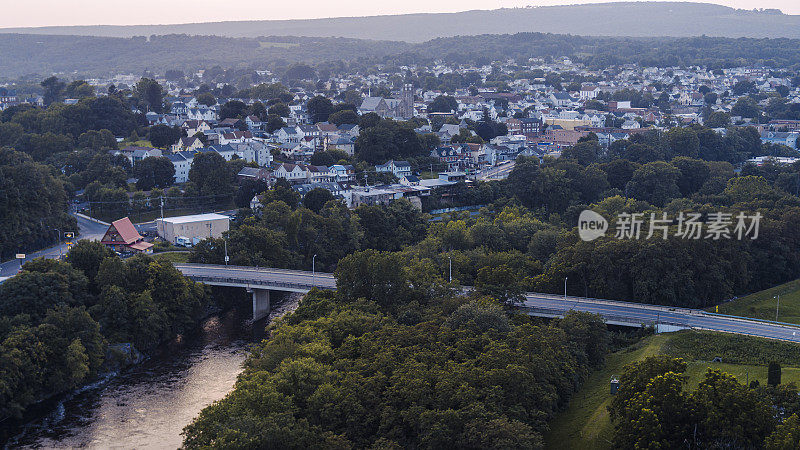 夕阳下的宾夕法尼亚州利哈伊河大桥:横跨在河岸上的一个小镇