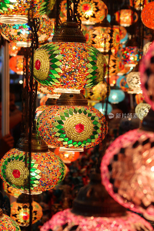 许多彩色的，马赛克玻璃球灯悬挂在天花板上，映衬着黑暗的背景，照亮了摩洛哥风格的灯笼室内照明