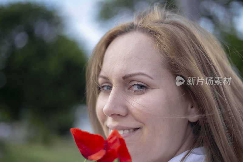 女人拿着罂粟，普通的罂粟，红色的花