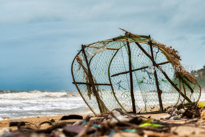 在暴风雨中，渔网和垃圾被冲上岸