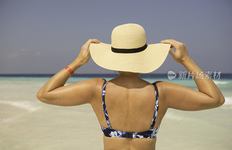 海滩上戴太阳帽的女人