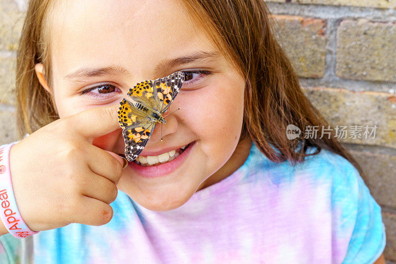 十岁的女孩，手指上有蝴蝶