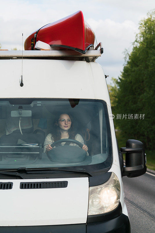 戴眼镜的女人开着露营车