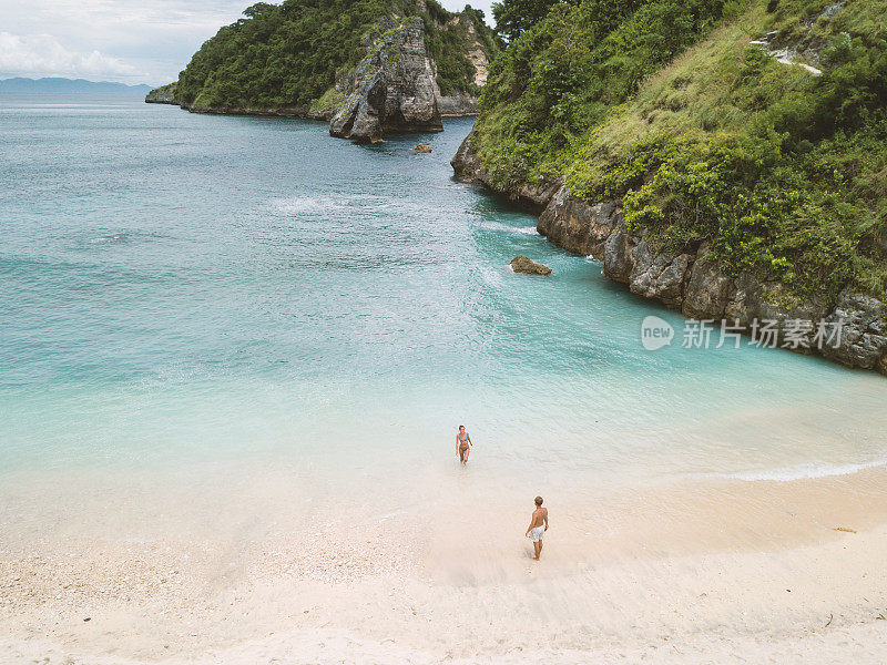 鸟瞰热带海滩上的年轻情侣享受度假和大自然，人们旅游探险的理念